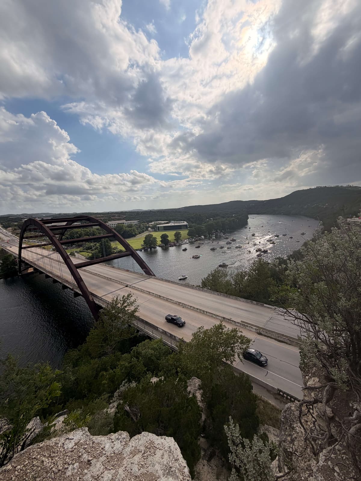 Pennybacker 360 Bridge overlooking Lake Austin with boats on the water