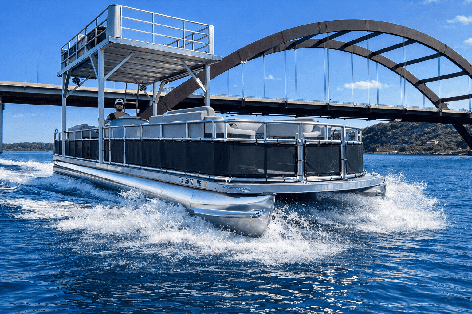 Double decker party boat under 360 Bridge on Lake Austin