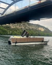 Party boat cruising under Pennybacker Bridge