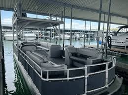 Luxury gray pontoon boat at marina on Lake Austin